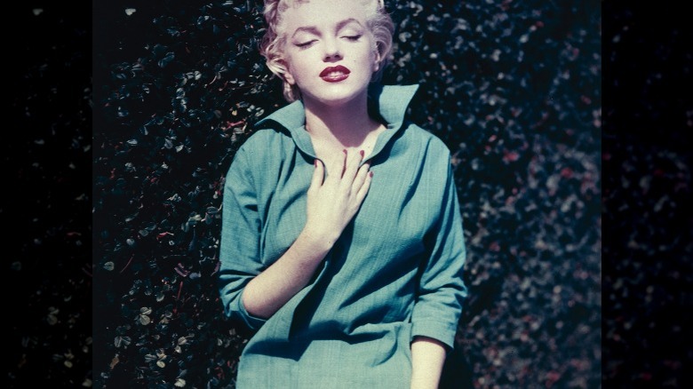 Marilyn Monroe standing outside, poses for a photo