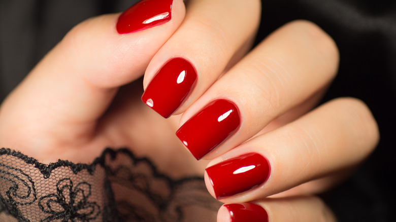A woman with red manicure 