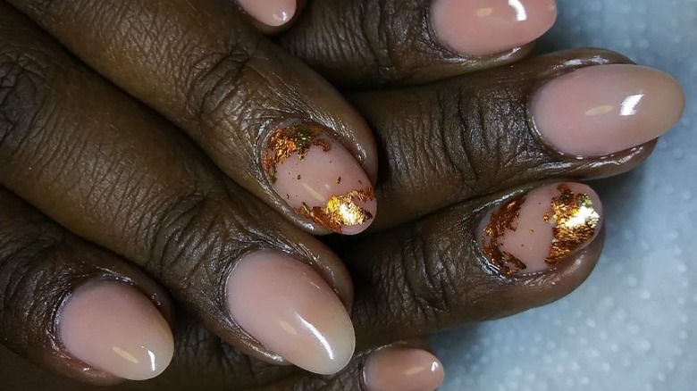 Neutral nails with gold flakes
