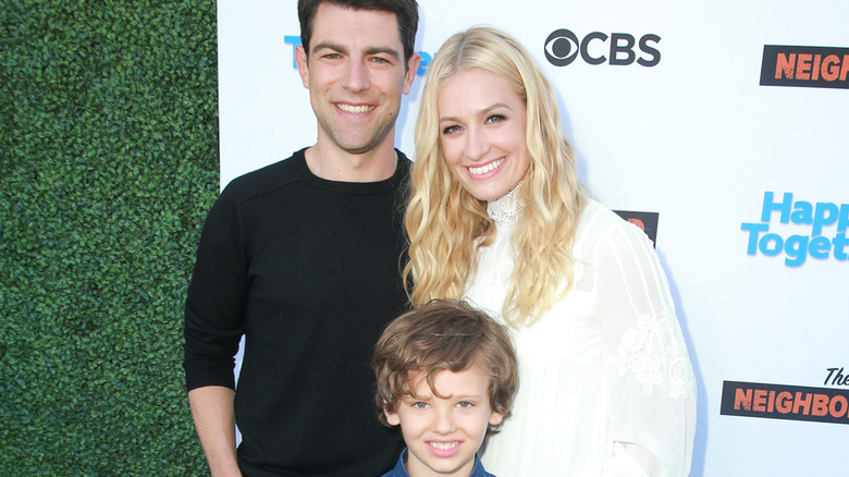 Beth Behrs and Max Greenfield posing with Hank Greenspan