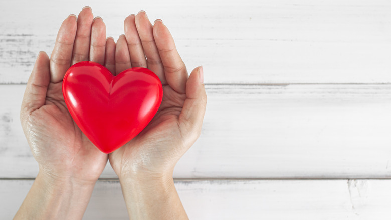 hands holding a red heart