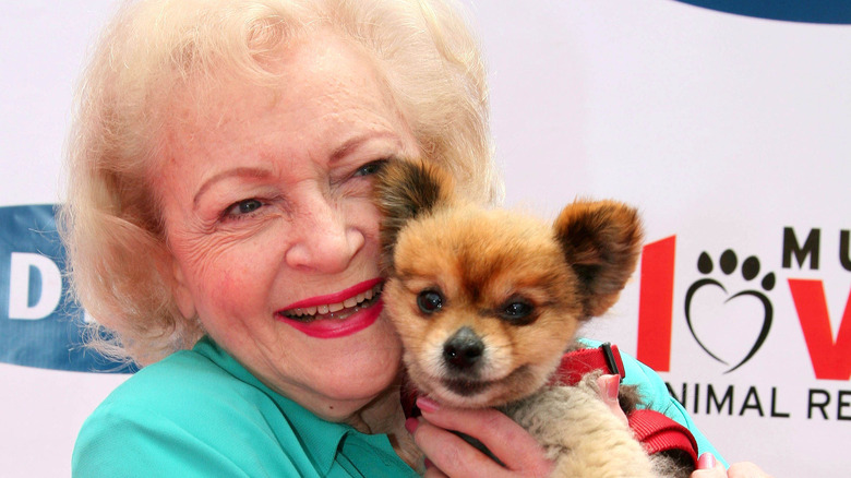 Betty White posing with a dog