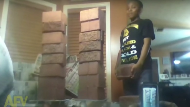 Boy making a brick tower on his table