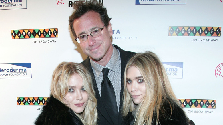 Bob Saget embracing the Olsen twins