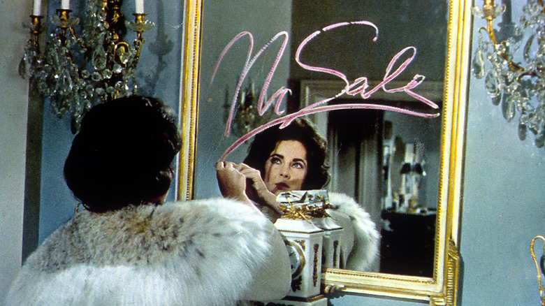 Elizabeth Taylor writing with lipstick on mirror