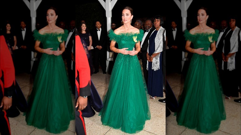 Kate Middleton wearing an all-green evening gown to a red carpet 