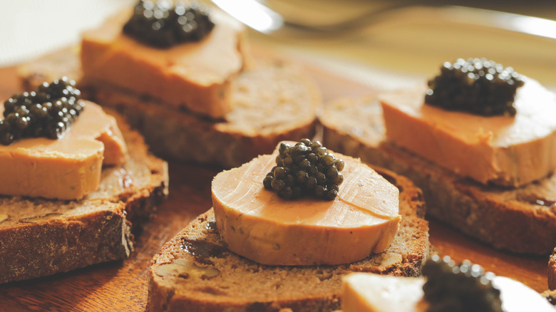 Foie gras served with sturgeon black caviar on slices of bread