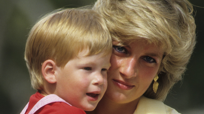 Princess Diana cuddles a young Prince Harry