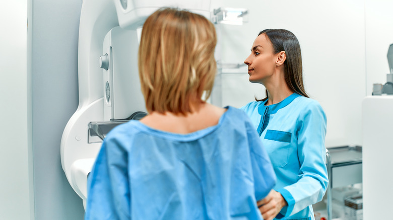 A woman undergoes a mammogram