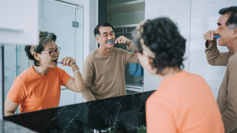 Couple brushing teeth together