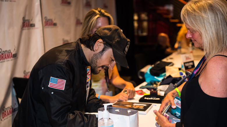 Tyler Hynes signing autograph for fan