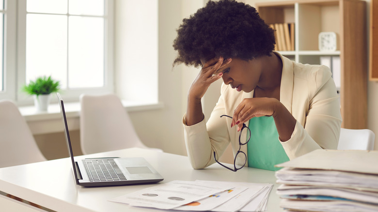 A woman suffering at work.