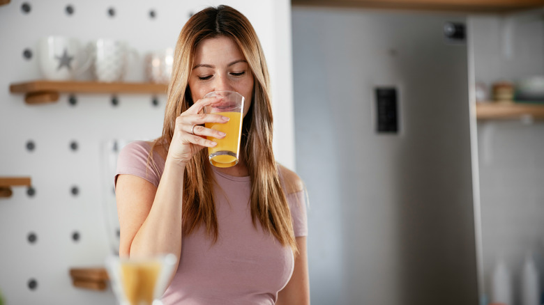 woman drinking orange juice