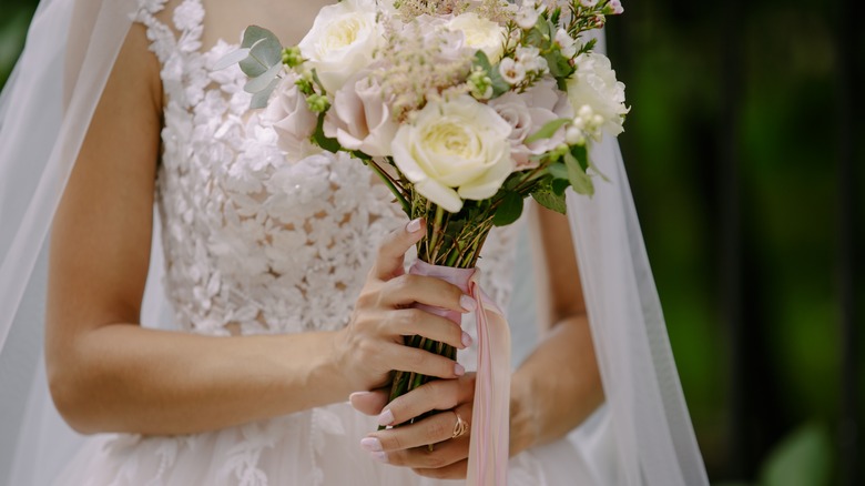 Bride holds a a bouquet of flowers