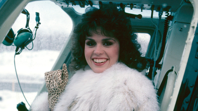 Marie Osmond smiling while seated in a helicopter 