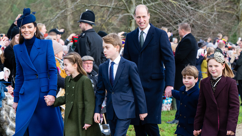 Kate Middleton and Prince William walking with Princess Charlotte, Prince George, and Prince Louis