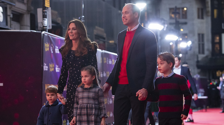 Prince William and Kate Middleton walking with Prince Louis, Princess Charlotte, and Prince George