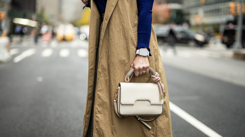 Woman holding white purse