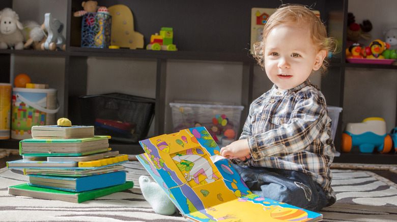 Baby boy holding a book