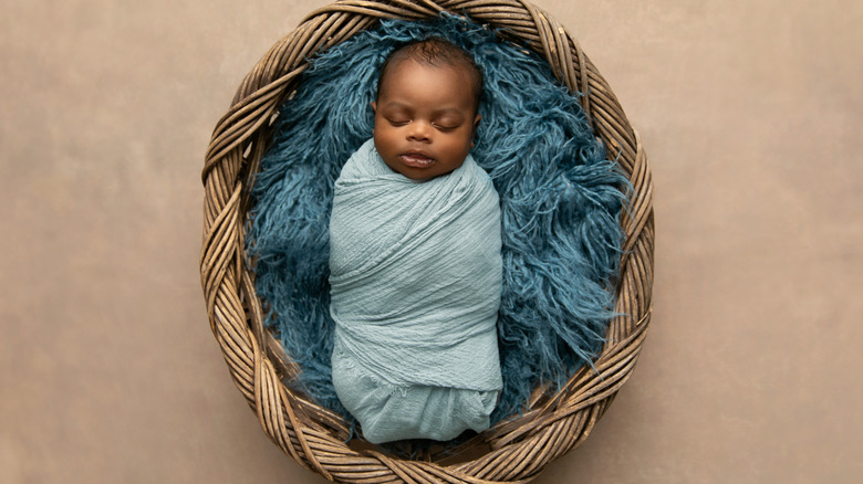 Baby boy sleeping in basket