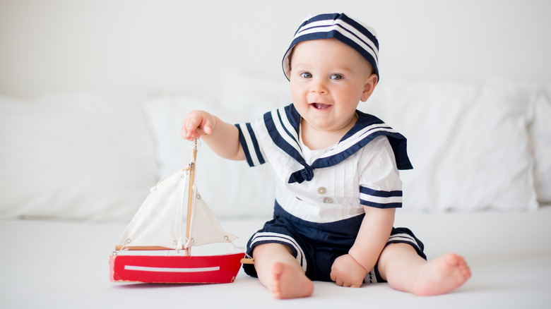 Baby boy with toy sailboat