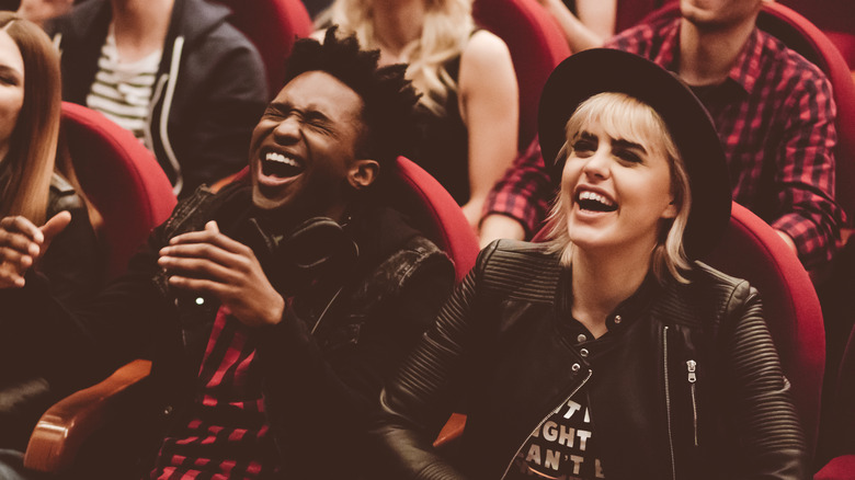 A couple laughing in theater