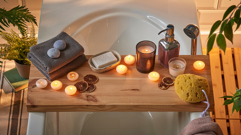 Bath tub, tray, lit candles 