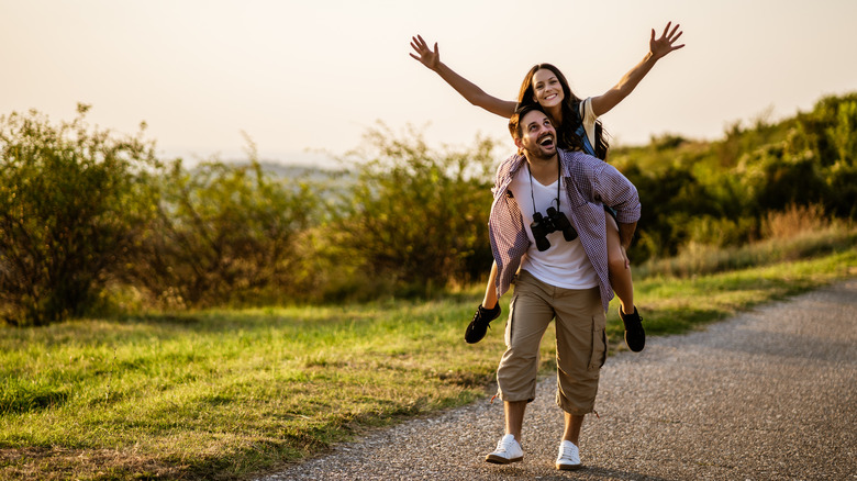 Woman on a man's back during a hike