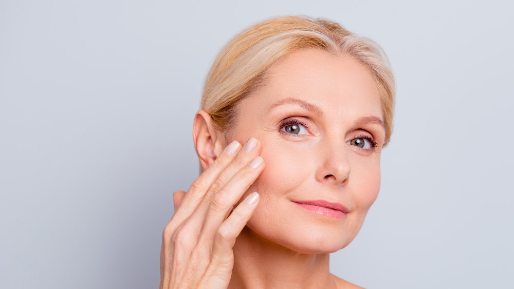 A woman holding her hand up to her face