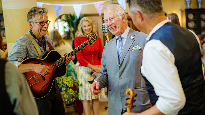 King Charles talking with guests