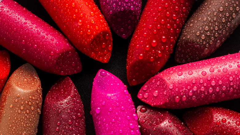 Several lipsticks covered in dew drops