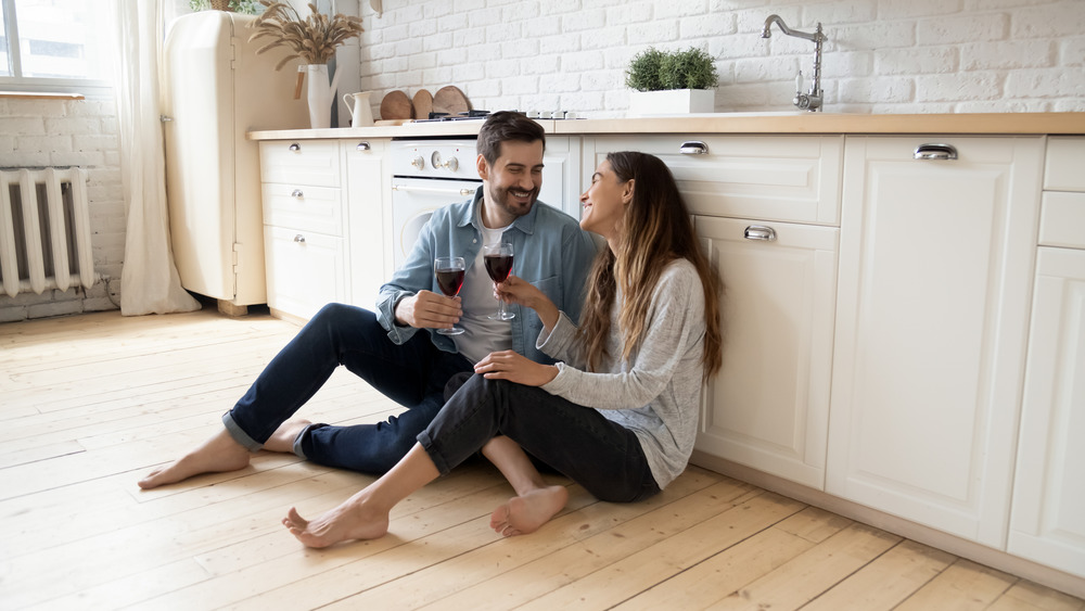 couple sitting on kitchen flooring