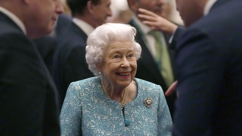 Britain's Queen Elizabeth II smiles while greeting guests during a reception for international business and investment leaders at Windsor Castle to mark the Global Investment Summit.
