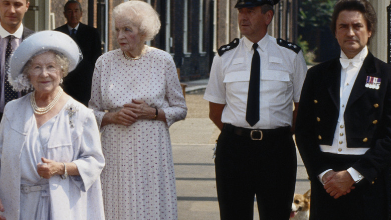 Tallon standing behind Queen Mother