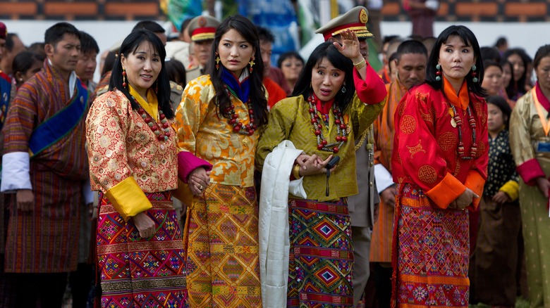 Jestun Pema standing with sister queen consorts