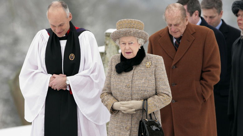 Queen Elizabeth Prince Philip and clergyman in snow