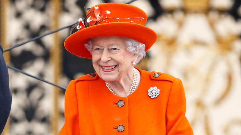 Queen Elizabeth smiling and looking to the side