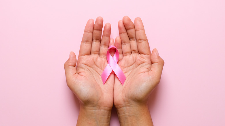 hands holding breast cancer ribbon