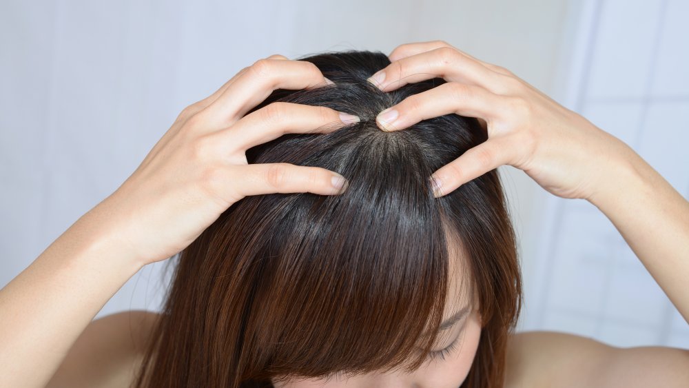 Woman massaging her scalp