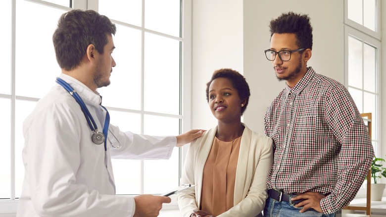 Doctor reassuring couple