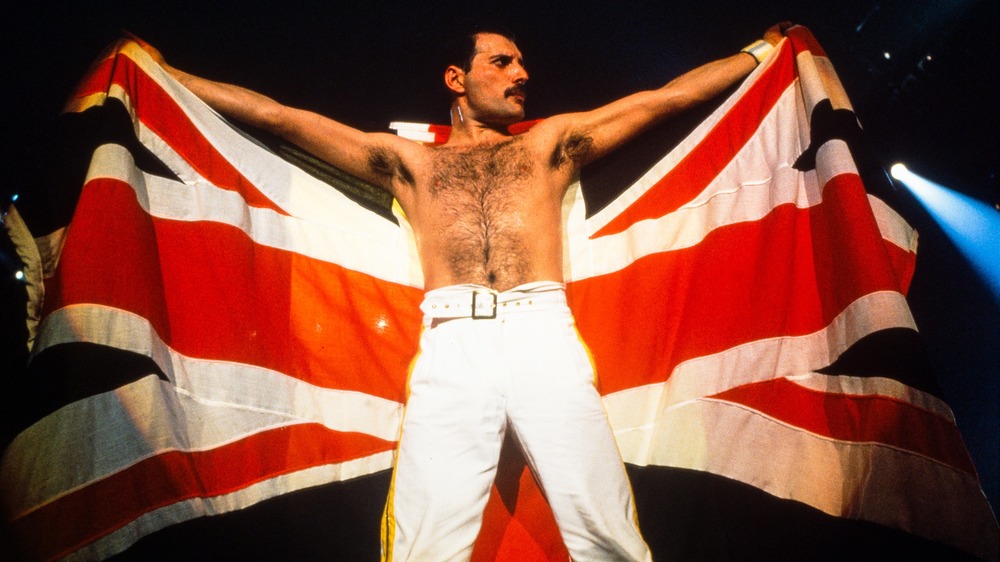 Freddie Mercury on stage with a British flag