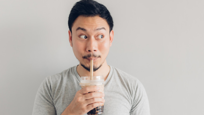 A man drinking bubble tea