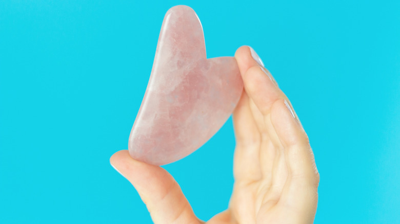 Woman holding Gua Sha Stone