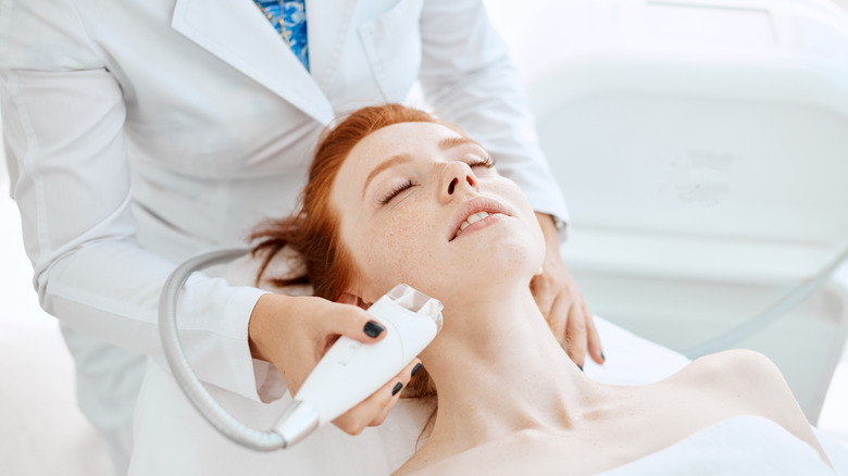 Woman having facial ultrasound treatment