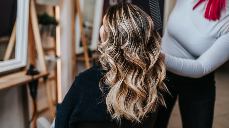 A woman getting her hair colored at the salon.