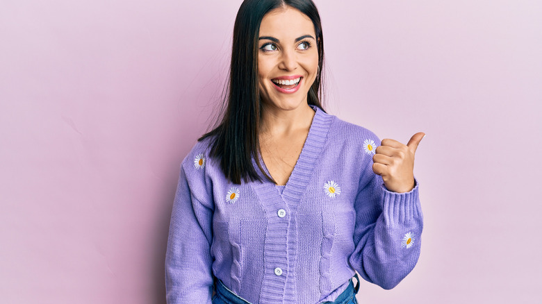 A woman in a purple cardigan