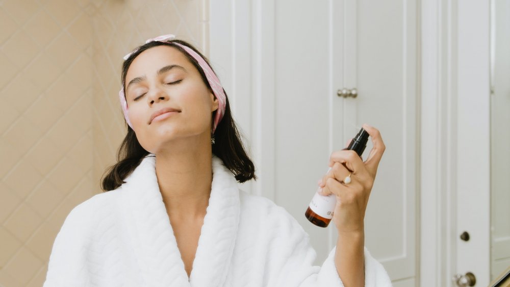 Woman spraying toner