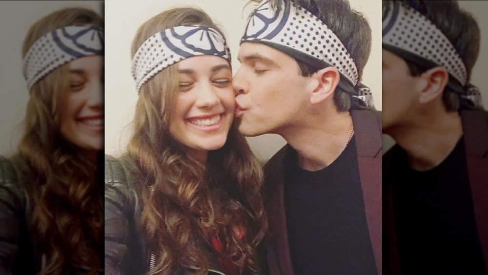 Cobra Kai's Mary Mouser and her partner, kissing her on the cheek