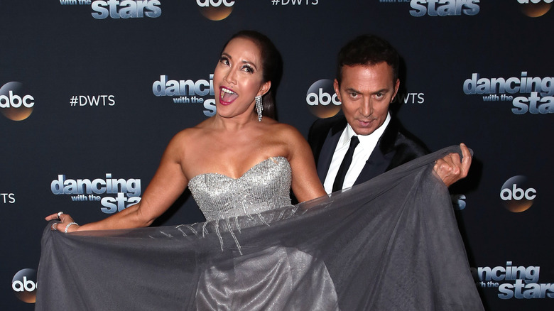 Carrie Ann Inaba and Bruno Tonioli smiling on the DWTS red carpet