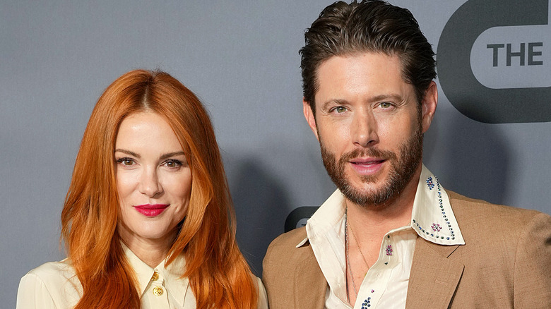 Jensen Ackles in brown coat with Danneel with red hair
